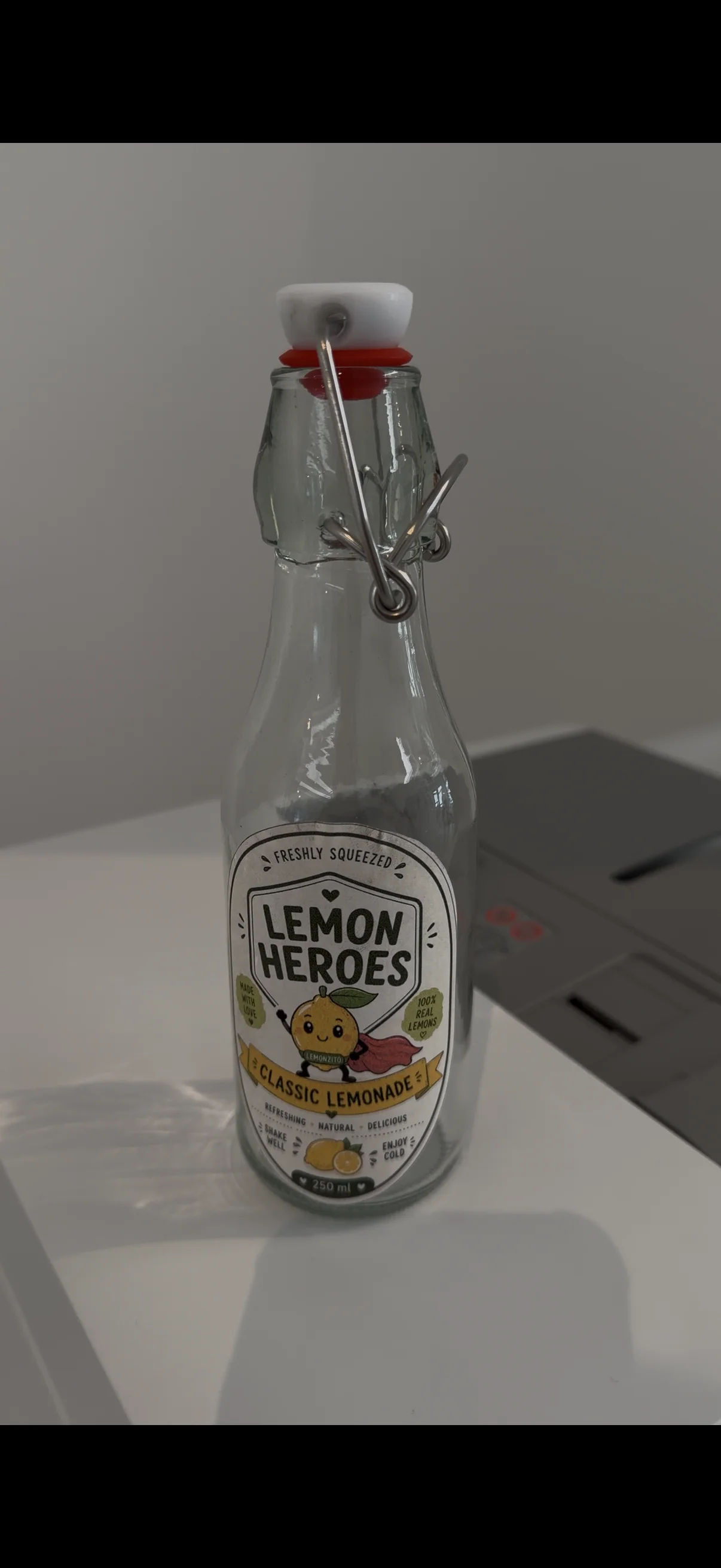 Glass swing-top bottle with the Lemon Heroes Classic Lemonade label