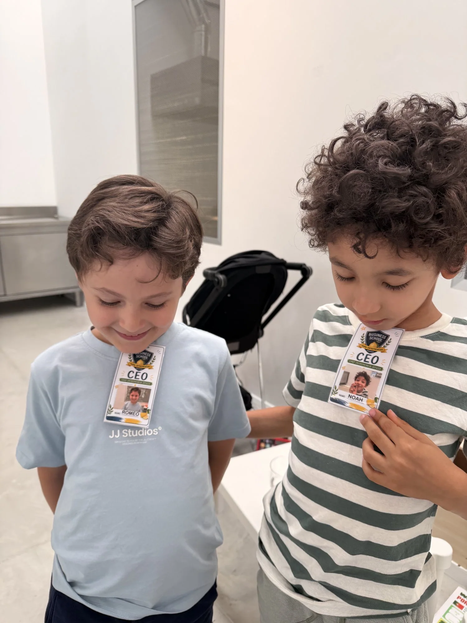 Noah and Roméo proudly wearing their CEO badges from business school