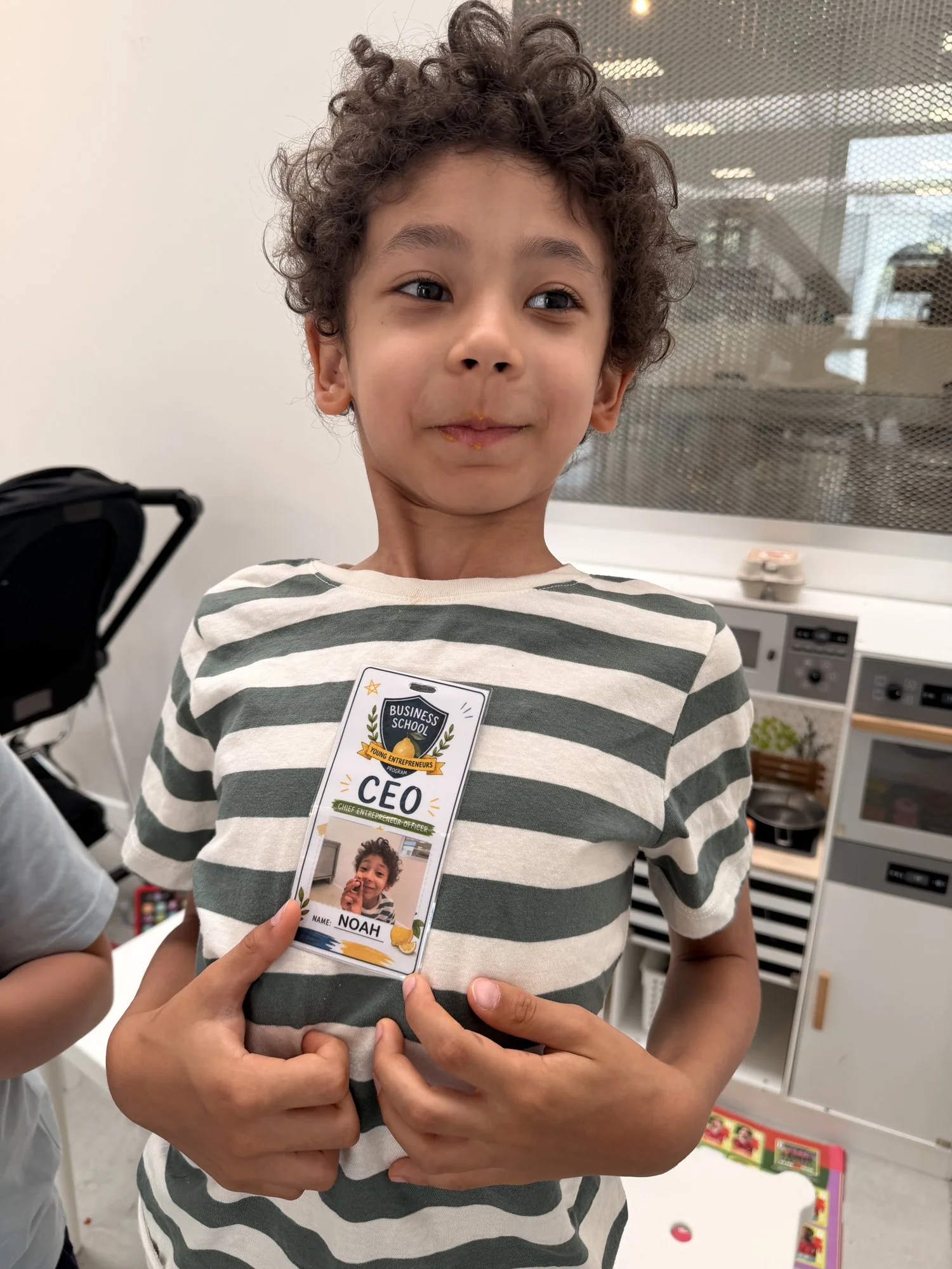 Noah showing his Business School for Young Entrepreneurs CEO badge