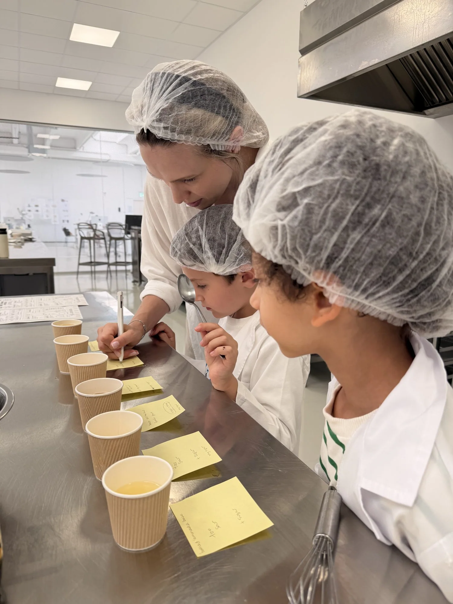 The founders taste-testing lemonade recipes from little cups